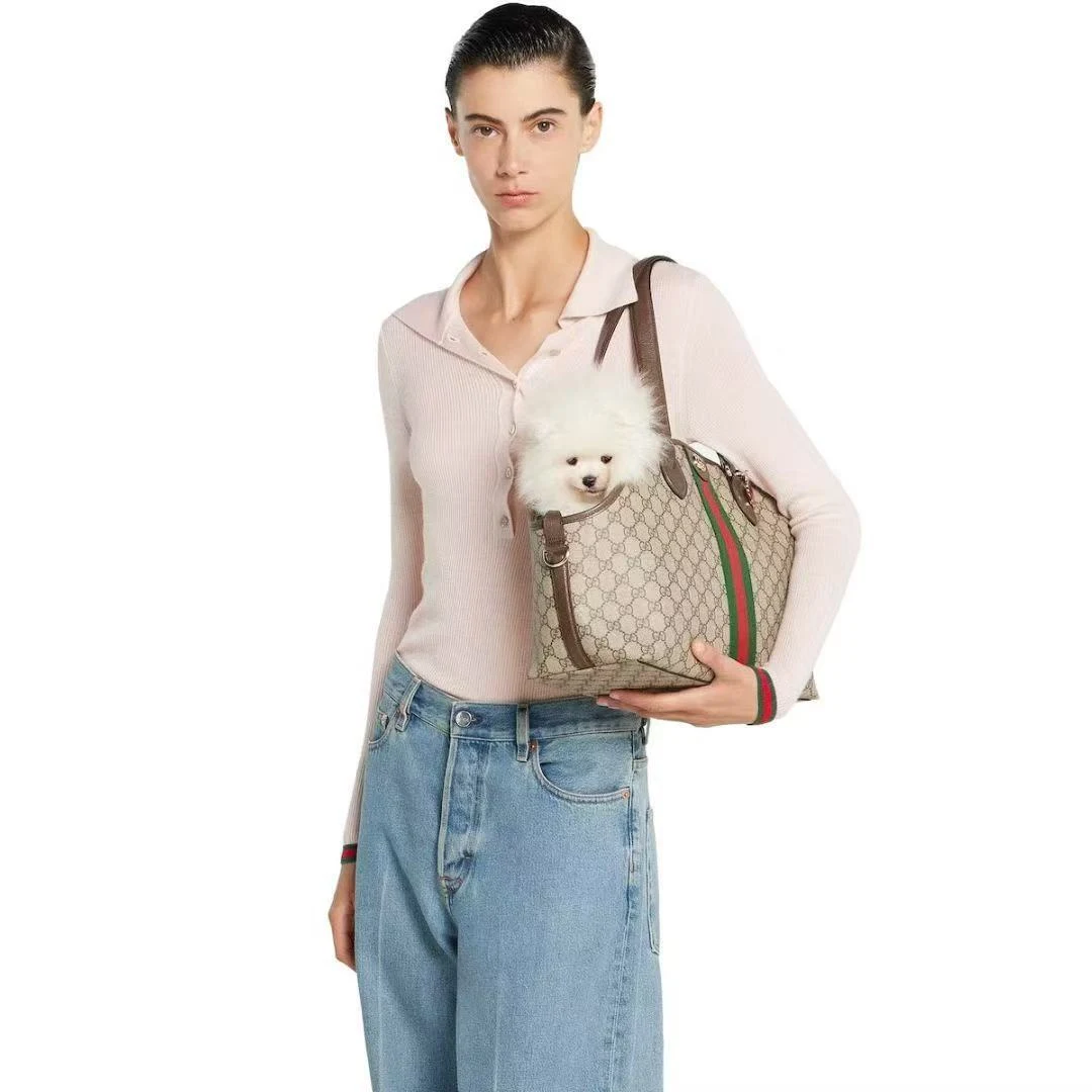 White Pomeranian peeking out of the Pawcci GG Monogram Designer Dog Carrier Tote, inspired by Gucci